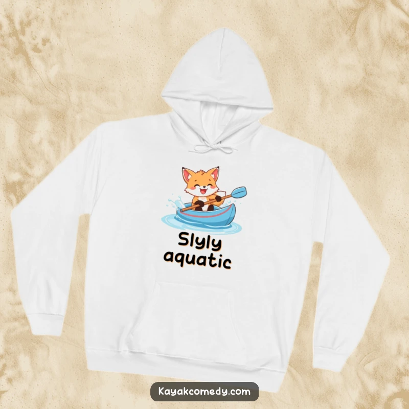 Funny Hoodie: A delighted fox cub splashes water enthusiastically from a blue kayak, a symbol of playful joy. Great gift.
