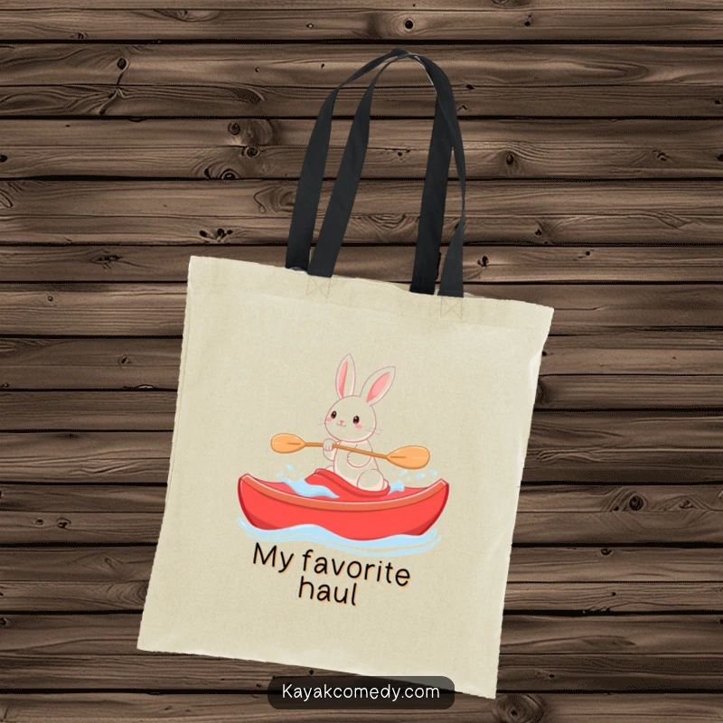 Funny Tote Bag: A playful rabbit steers a red kayak through gentle waves, a charming image of serene fun. Perfect gift.